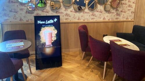Portable digital A-board used for promotions in coffee shop