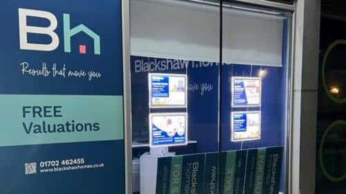 Window vinyl and LED poster pockets outside Blackshaw Homes estate agent